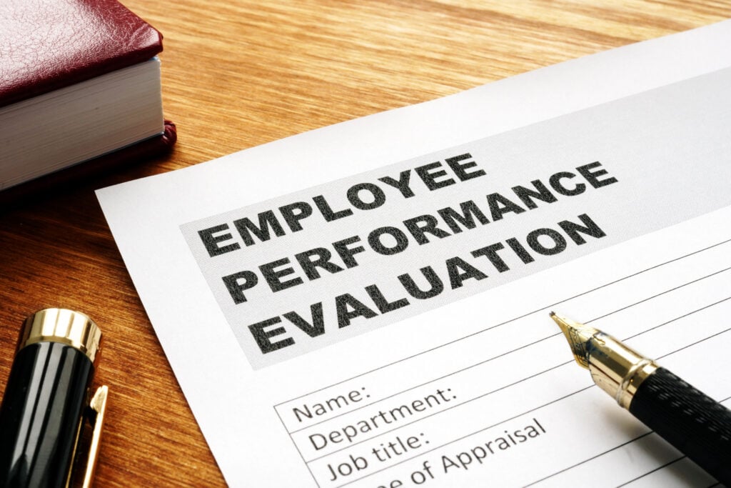 Employee performance evaluation form on a desk.