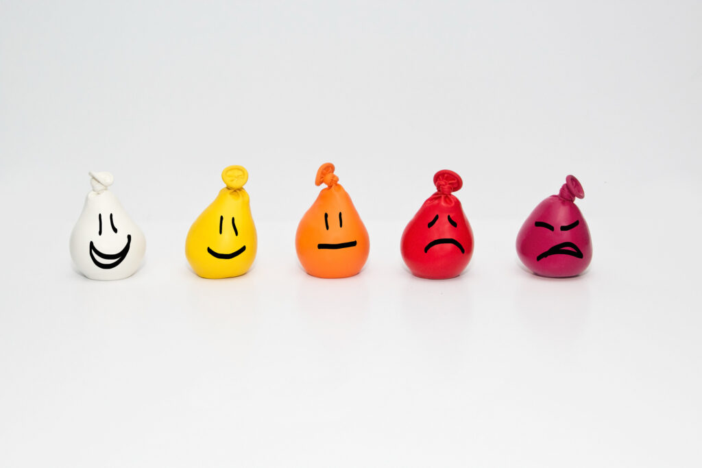 different doodle faces on coloured balloons